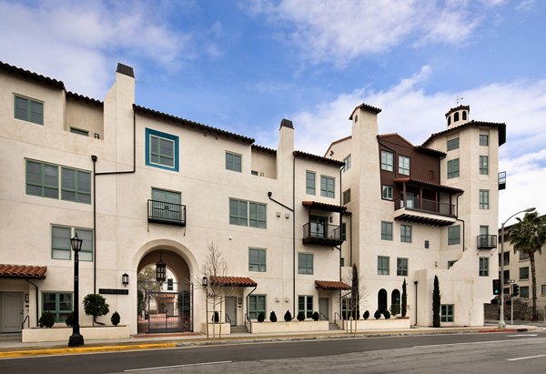 Andalucia Apartments: Elegant facade and lush landscaping at luxury community in Los Angeles