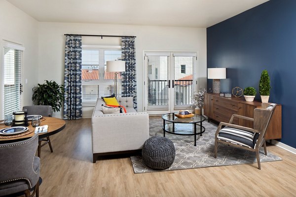 Living room with contemporary design and plush seating at Andalucia Apartments, luxury Greystar property