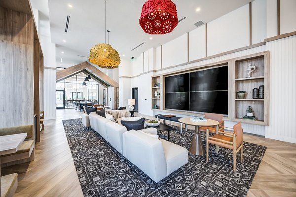 Clubhouse at Esperanza at Duarte Station Apartments: Modern design with lounge seating and entertainment area