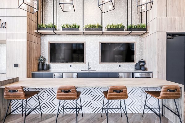 Esperanza at Duarte Station: modern clubhouse featuring sleek furnishings and open concept layout