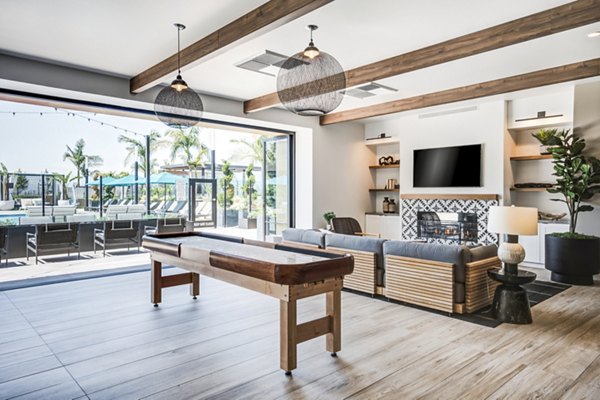 Clubhouse at Esperanza: Modern lounging area with cozy seating and a fireplace in Duarte Station Apartments, perfect for community gatherings