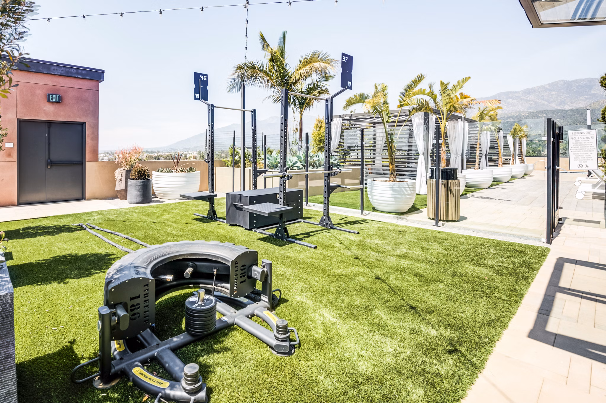 Outdoor fitness center with modern equipment at Esperanza at Duarte Station Apartments, offering luxury Greystar apartment amenities