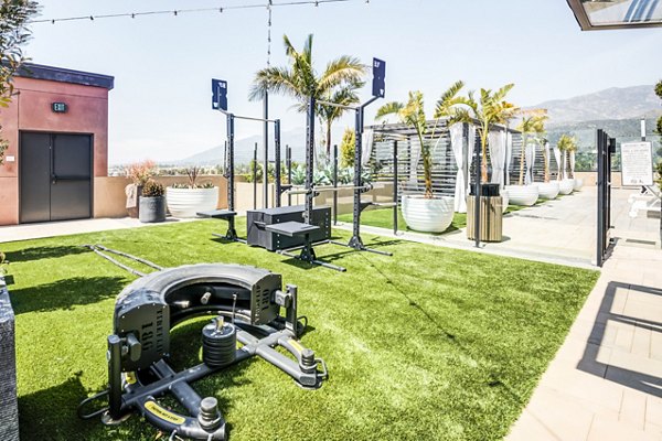 Outdoor fitness center with modern equipment at Esperanza at Duarte Station Apartments, offering luxury Greystar apartment amenities