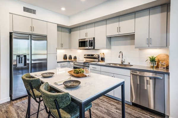 Dining area with modern kitchen fixtures at Esperanza at Duarte Station Apartments