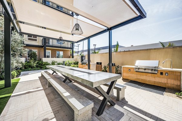 Outdoor grill area on patio at Esperanza at Duarte Station Apartments