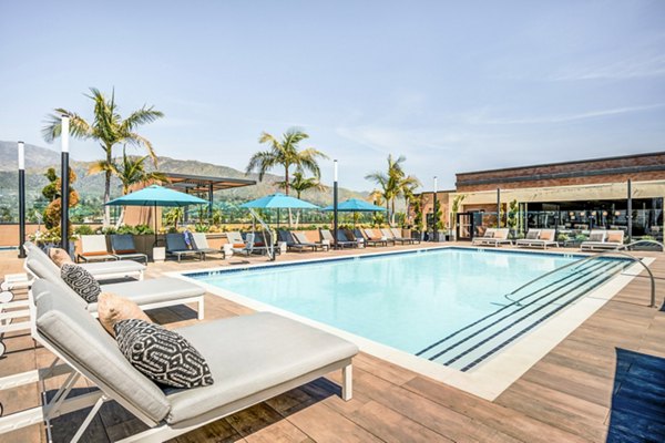 Resort-style pool with cabanas at Esperanza at Duarte Station Apartments, offering luxury relaxation for residents