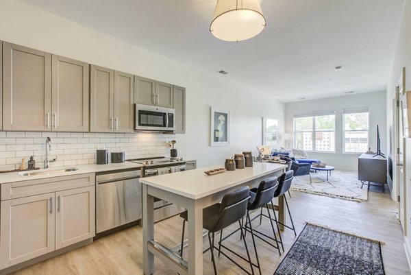 Modern kitchen with stainless steel appliances at Centro Arlington Apartments, offering a luxurious living experience in a prime location