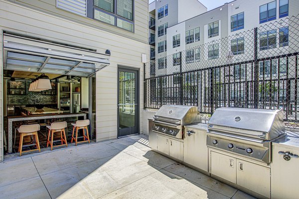 Outdoor grill area with modern seating at Centro Arlington Apartments