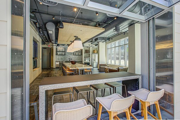 Patio with modern seating and lush greenery at Centro Arlington Apartments