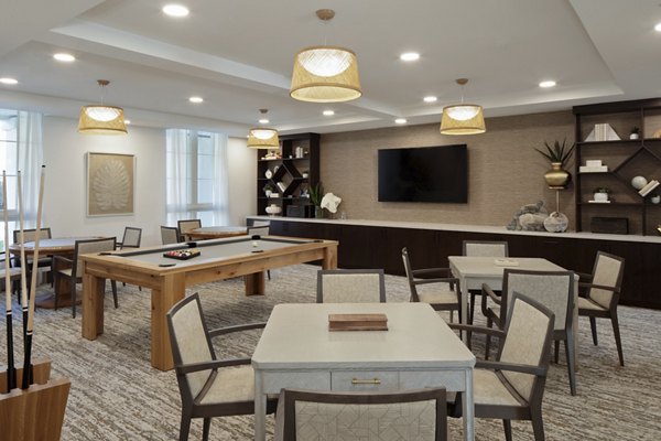 Modern clubhouse with cozy seating and a fireplace at Everleigh San Clemente Apartments