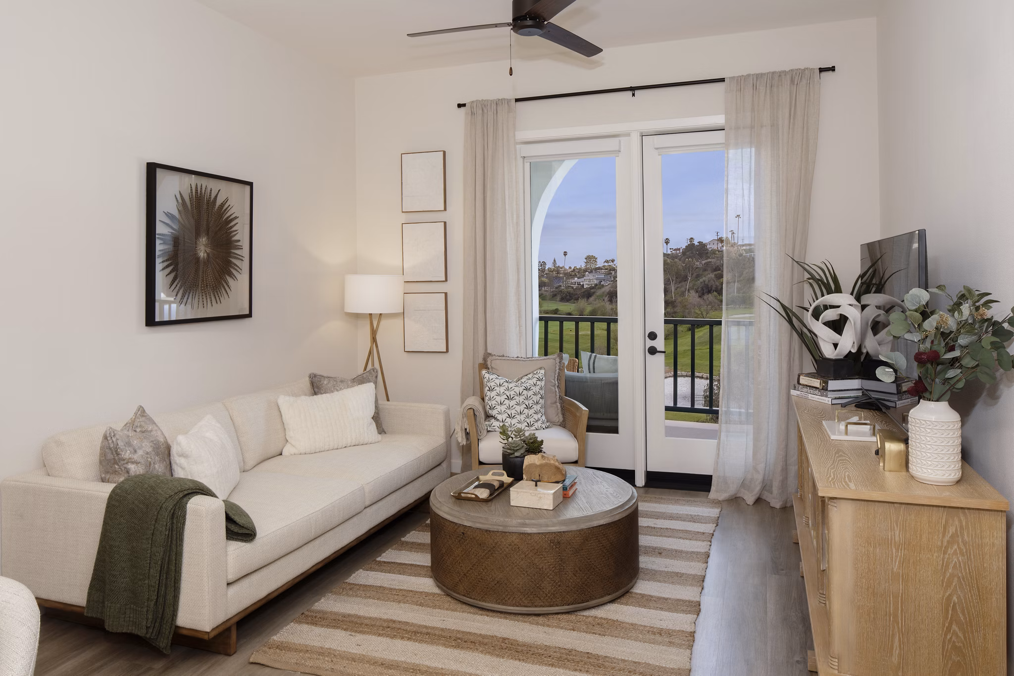 Spacious living room with modern decor and ocean views at Everleigh San Clemente Apartments