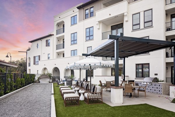 Courtyard featuring lush landscaping and outdoor seating at Everleigh San Clemente luxury apartments