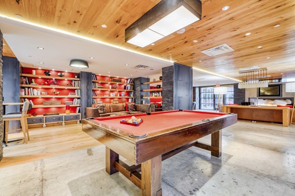 Stylish game room with pool table and modern decor at Notch8 Apartments, offering luxury living in a vibrant community