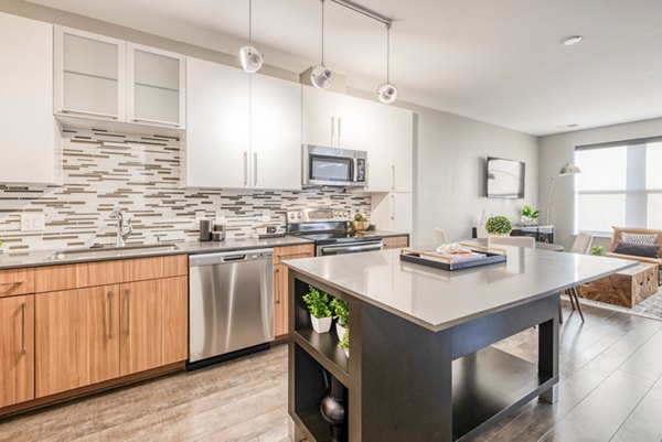 Modern kitchen with stainless steel appliances at Notch8 Apartments