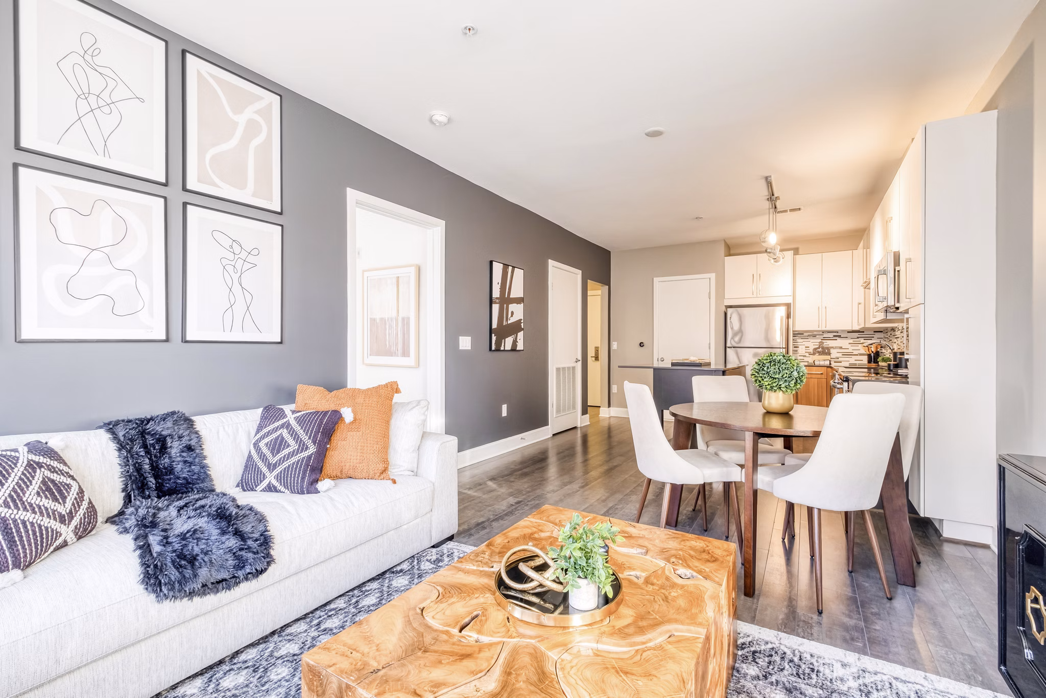 Spacious living room with modern furniture and natural light at Notch8 Apartments