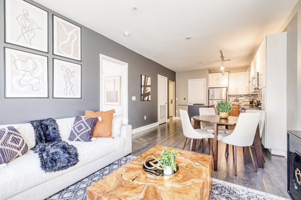 Spacious living room with modern furniture and natural light at Notch8 Apartments