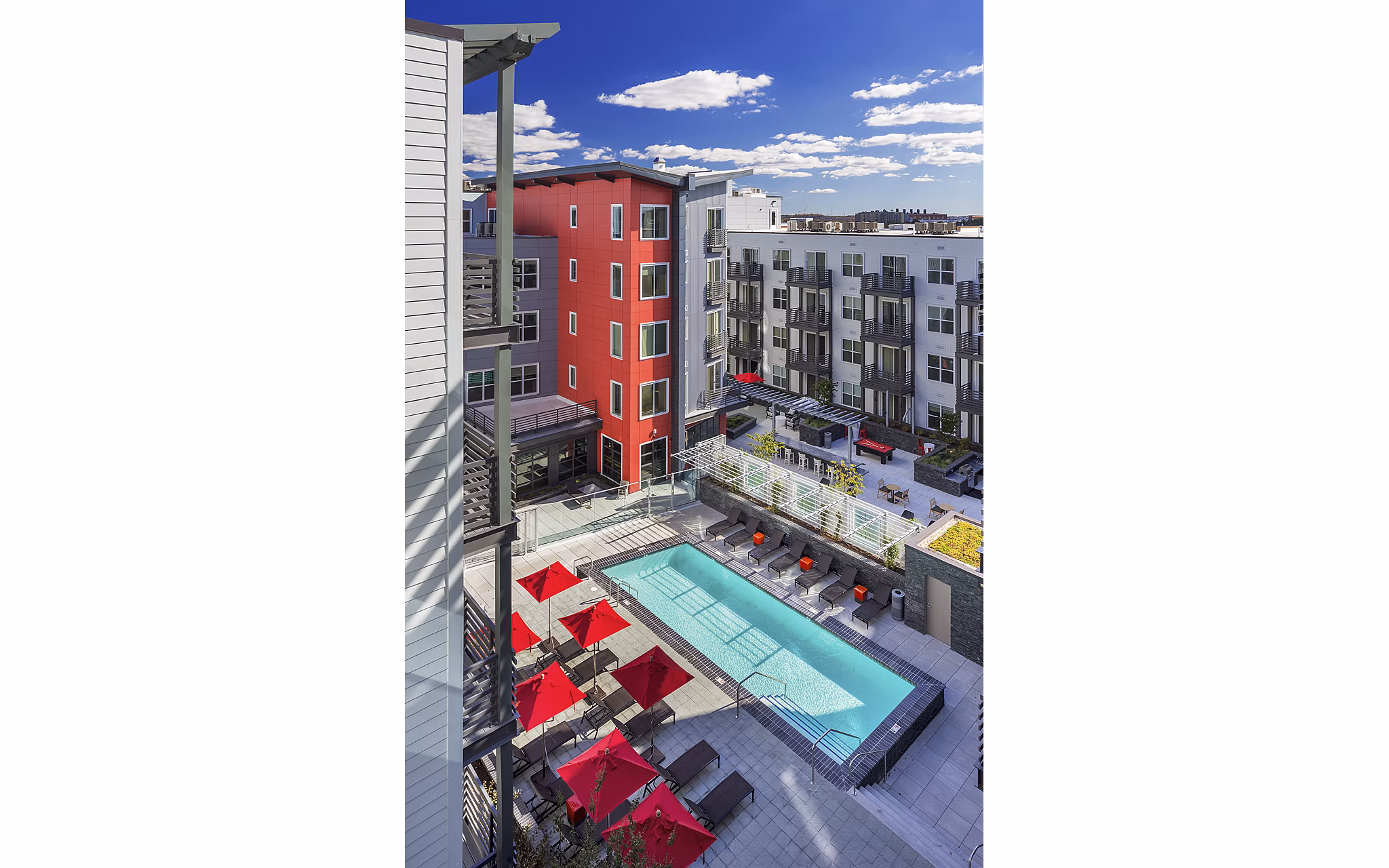 Luxury outdoor pool with lounge chairs at Notch8 Apartments