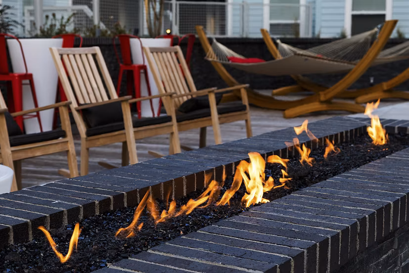 Cozy outdoor fire pit at Notch8 Apartments, ideal for relaxing and socializing in luxury surroundings