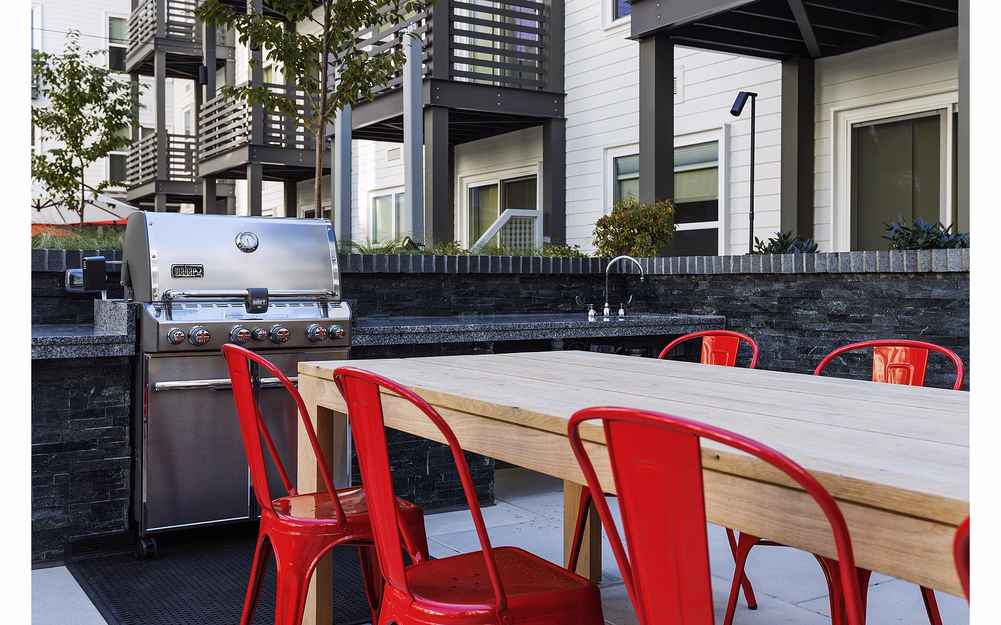 Grill area with modern seating at Notch8 Apartments in San Jose