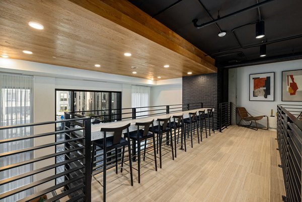 The Signal Apartments: Modern clubhouse featuring comfortable seating and ambient lighting