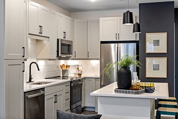 Modern kitchen with stainless steel appliances at The Signal Apartments