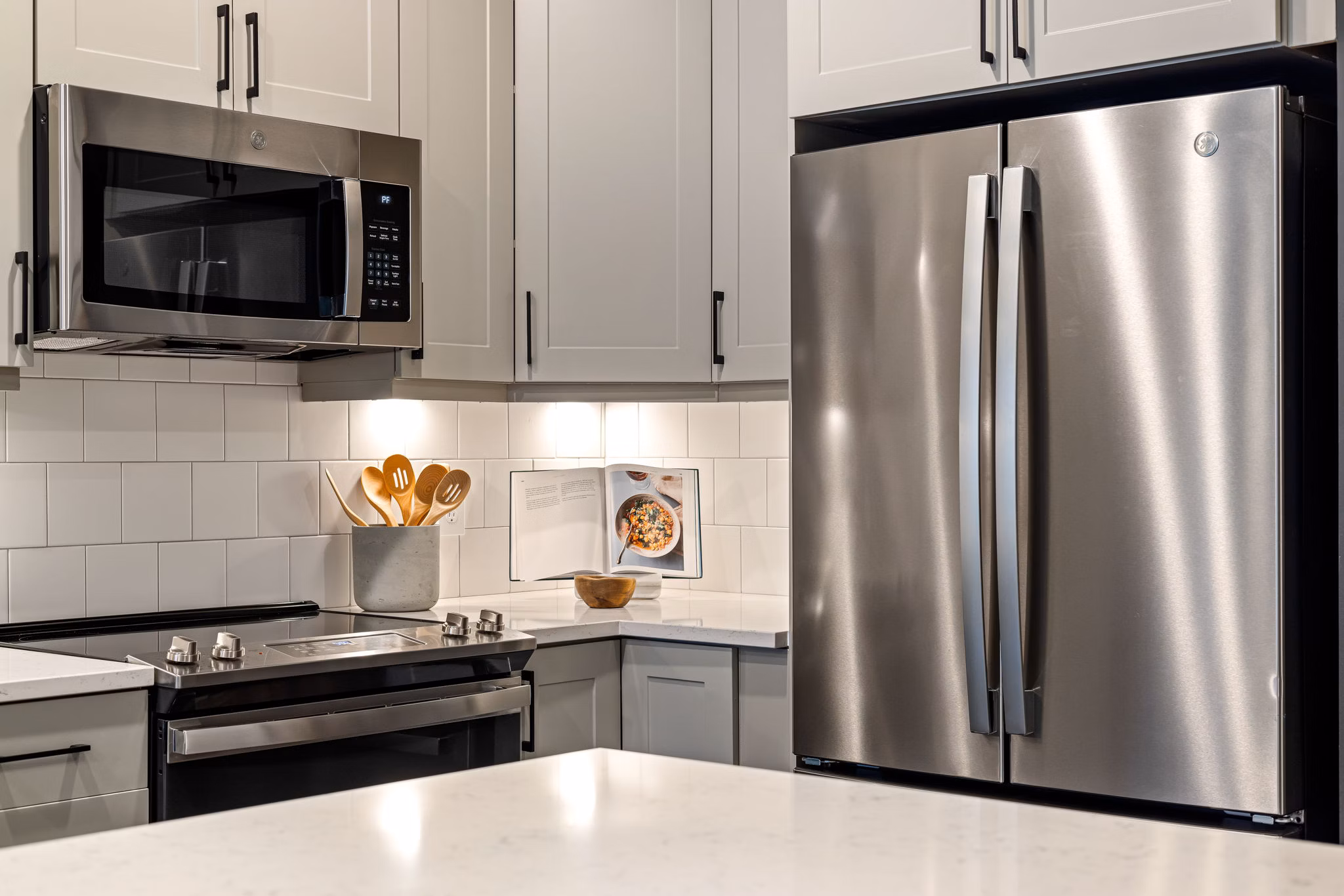 Modern kitchen with stainless steel appliances in The Signal Apartments