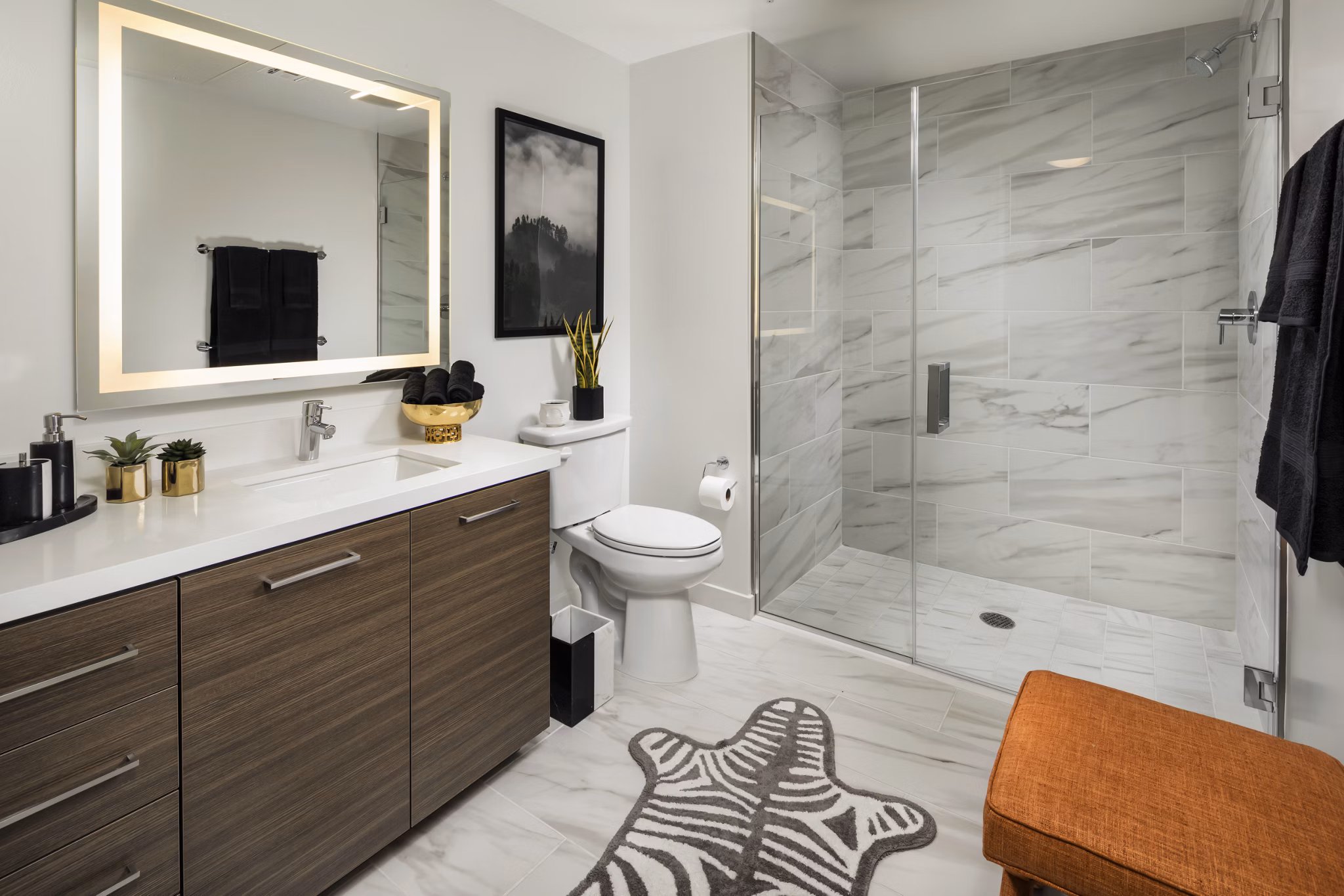Modern bathroom with marble countertops and sleek fixtures at Next on Lex Apartments