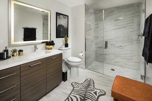 Modern bathroom with marble countertops and sleek fixtures at Next on Lex Apartments