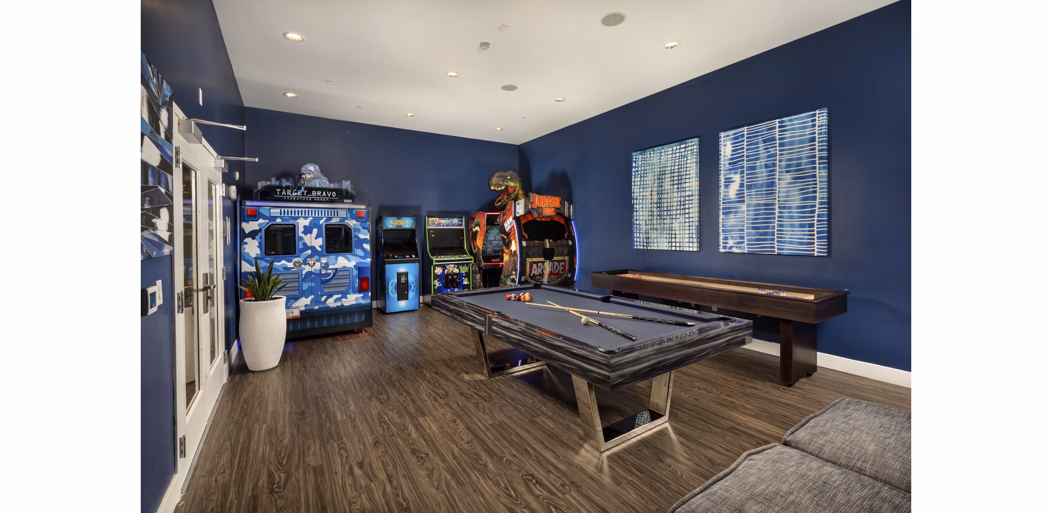 Game room with billiards table and cozy seating at Next on Lex Apartments in Glendale
