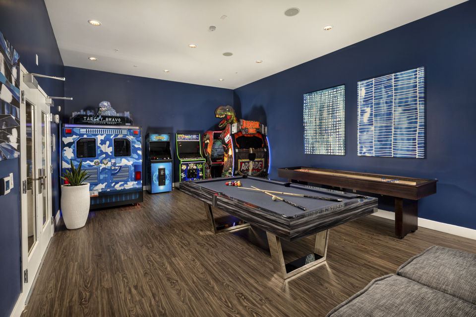 Game room with billiards table and cozy seating at Next on Lex Apartments in Glendale