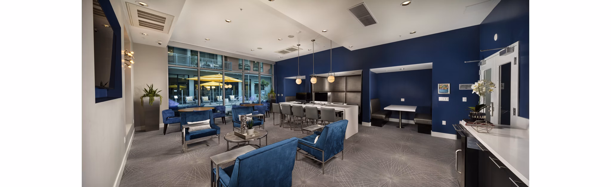 Contemporary clubhouse with stylish seating and decor at Next on Lex Apartments in Glendale, ideal for socializing and relaxation