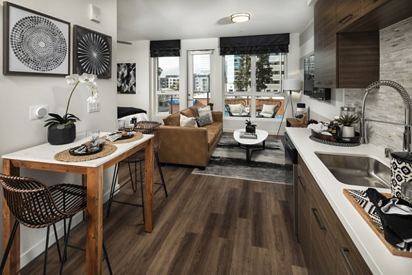 Modern kitchen with stainless steel appliances and island countertop at Next on Lex Apartments, ideal for luxury living in Glendale