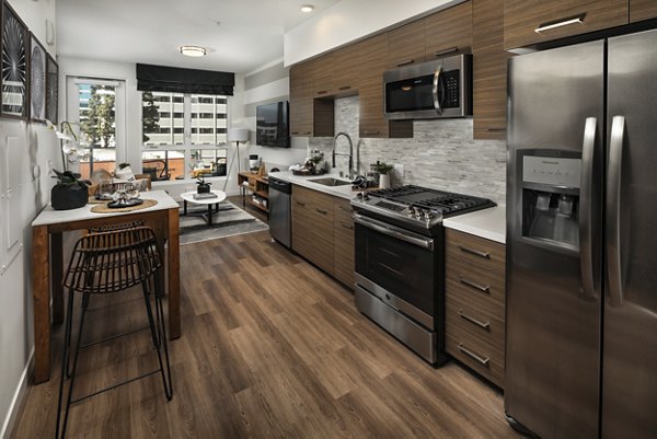 Modern kitchen with stainless steel appliances at Next on Lex Apartments