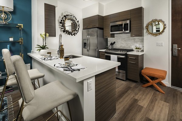 Modern kitchen featuring stainless steel appliances at Next on Lex Apartments