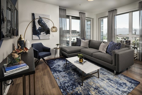 Contemporary living room with stylish decor and ample natural light at Next on Lex luxury apartments