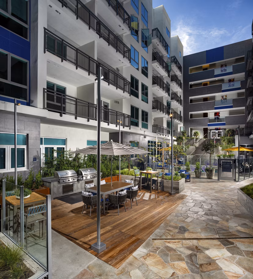 Outdoor grill area with modern appliances at Next on Lex Apartments, ideal for gatherings and barbecues in a luxury setting