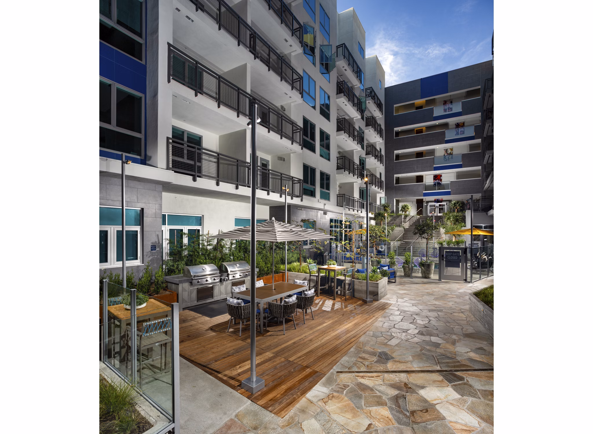 Outdoor grill area with modern appliances at Next on Lex Apartments, ideal for gatherings and barbecues in a luxury setting