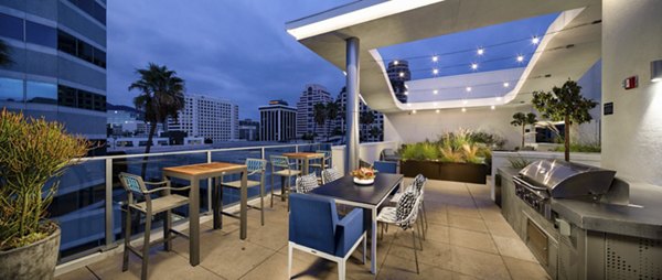 Spacious outdoor grill area with modern seating at Next on Lex Apartments, perfect for social gatherings and relaxation