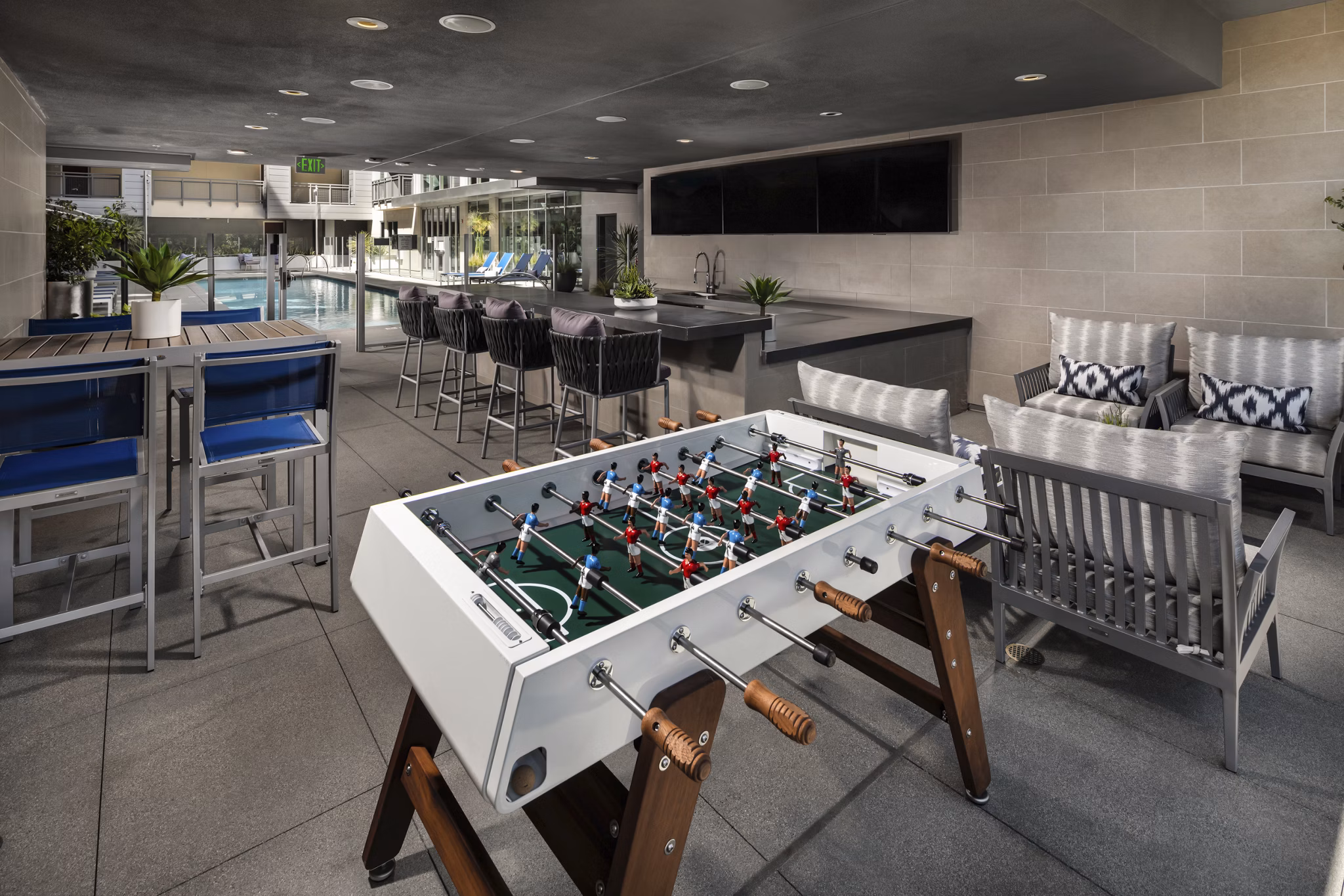Spacious outdoor patio with modern seating at Next on Lex Apartments in Glendale, offering relaxed alfresco living