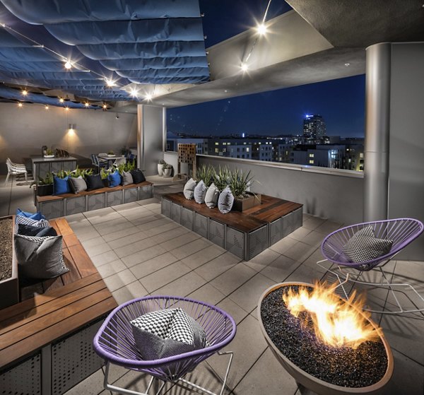 Fire pit and outdoor seating area at Next on Lex Apartments in Glendale, offering a cozy amenity for gatherings and relaxation
