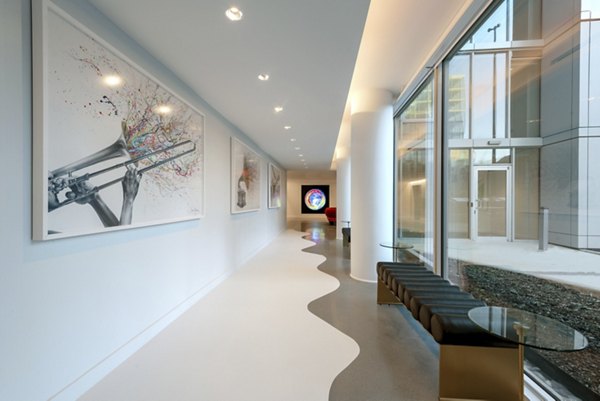 Gallery 64 Apartments: Modern clubhouse with stylish seating and artwork displays