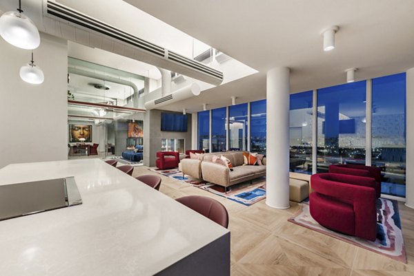 Clubhouse lounge with modern decor and spacious seating at Gallery 64 Apartments