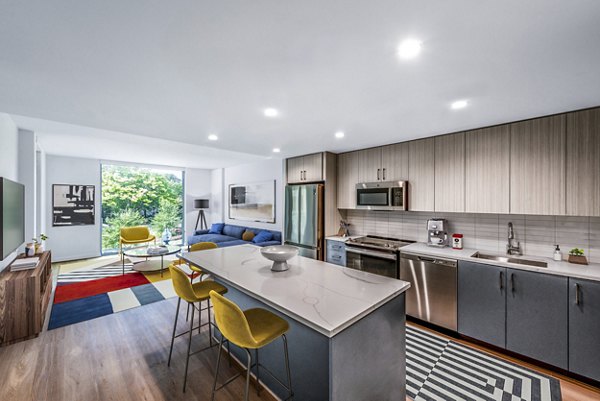 Kitchen with sleek countertops and modern appliances in GS Gallery 64 luxury apartments