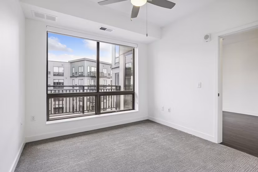 Bedroom featuring contemporary decor and natural light at Avidor Edina Apartments