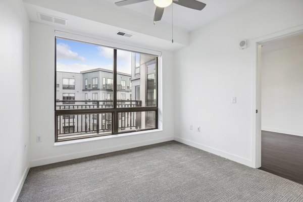 Bedroom featuring contemporary decor and natural light at Avidor Edina Apartments