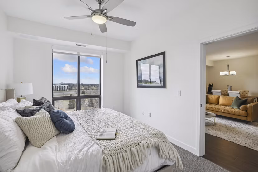 Bedroom featuring contemporary design with plush bedding at Avidor Edina Apartments - luxury living for seniors