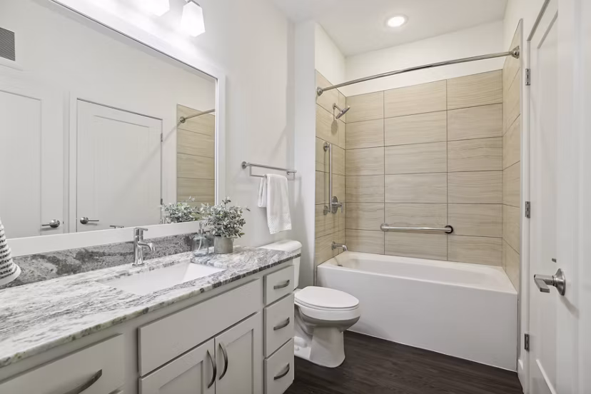 Modern bathroom with elegant fixtures at Avidor Edina luxury apartments, showcasing sleek design and high-end finishes in a serene setting
