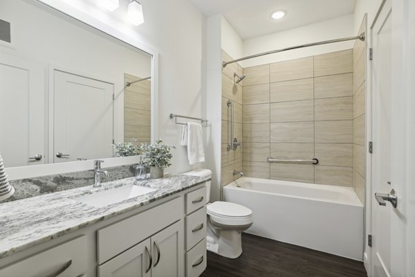 Modern bathroom with elegant fixtures at Avidor Edina luxury apartments, showcasing sleek design and high-end finishes in a serene setting