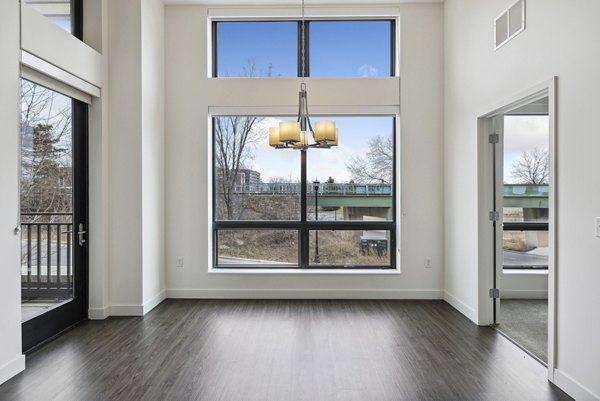 Dining area featuring elegant decor and modern lighting at Avidor Edina Apartments