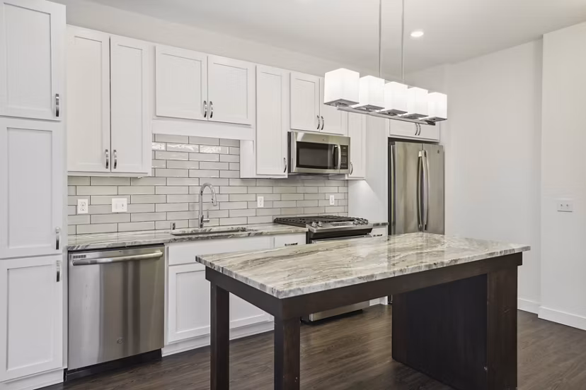 Modern kitchen featuring sleek cabinetry and stainless steel appliances at Avidor Edina Apartments